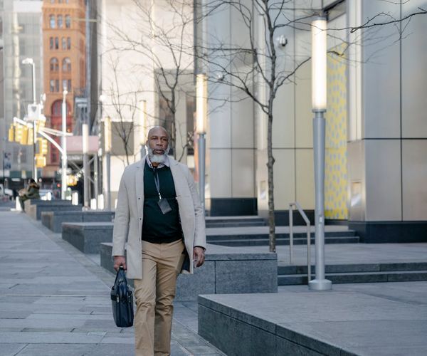 Man looking at a sunrise, representing a new start and daily routine.