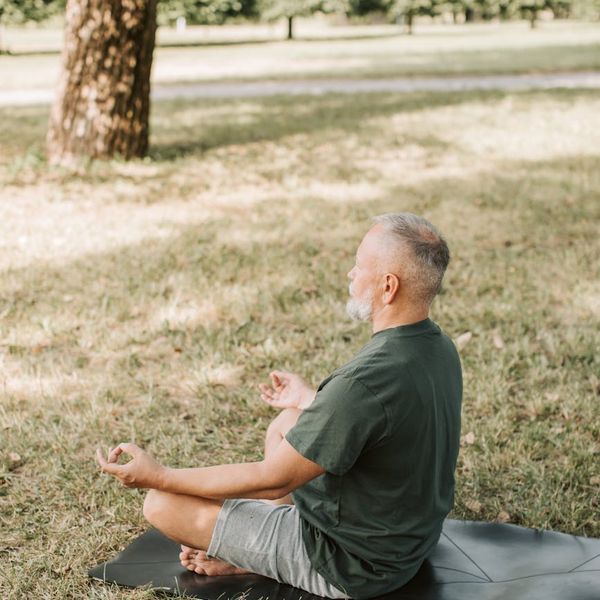 Man meditating in a calm environment, representing inner balance.